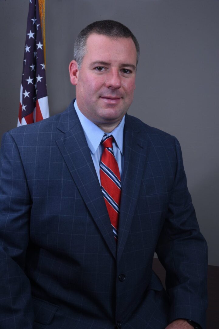 Man in a blue coat and red tie