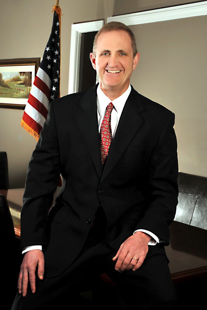 Man in a black coat and red tie