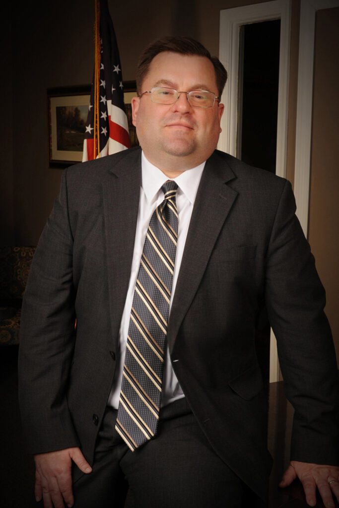 Formal portrait with American flag backdrop