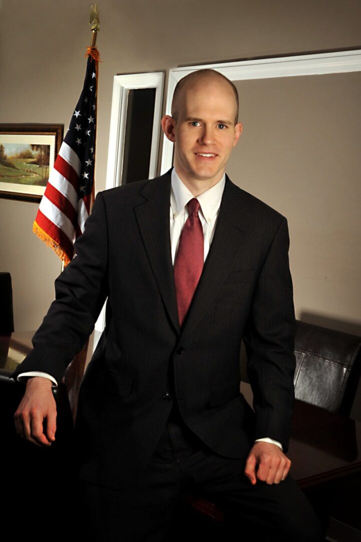 Man in a black suit and red tie